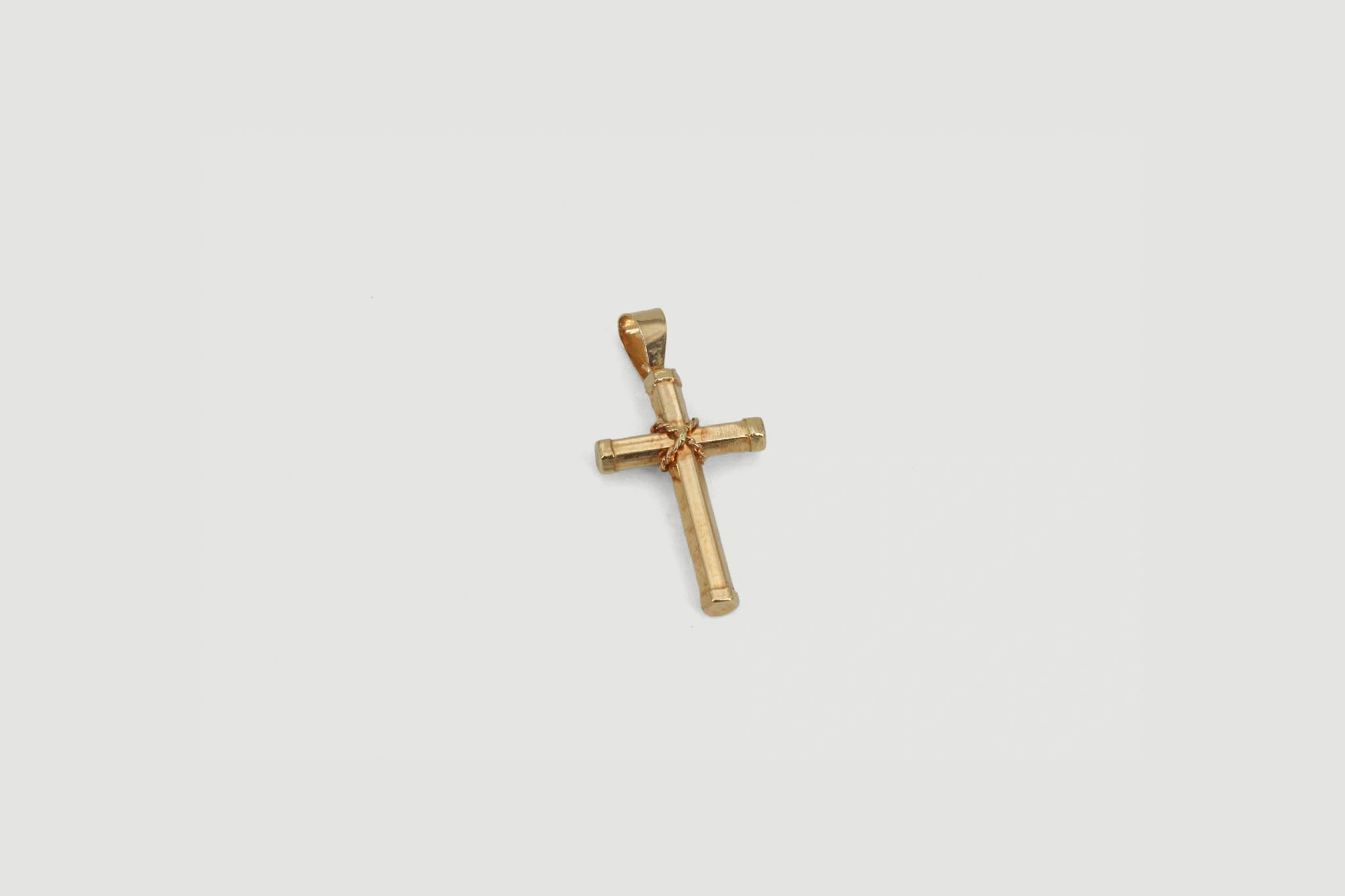 Cruz de oro de 18k con detalle entrelazado