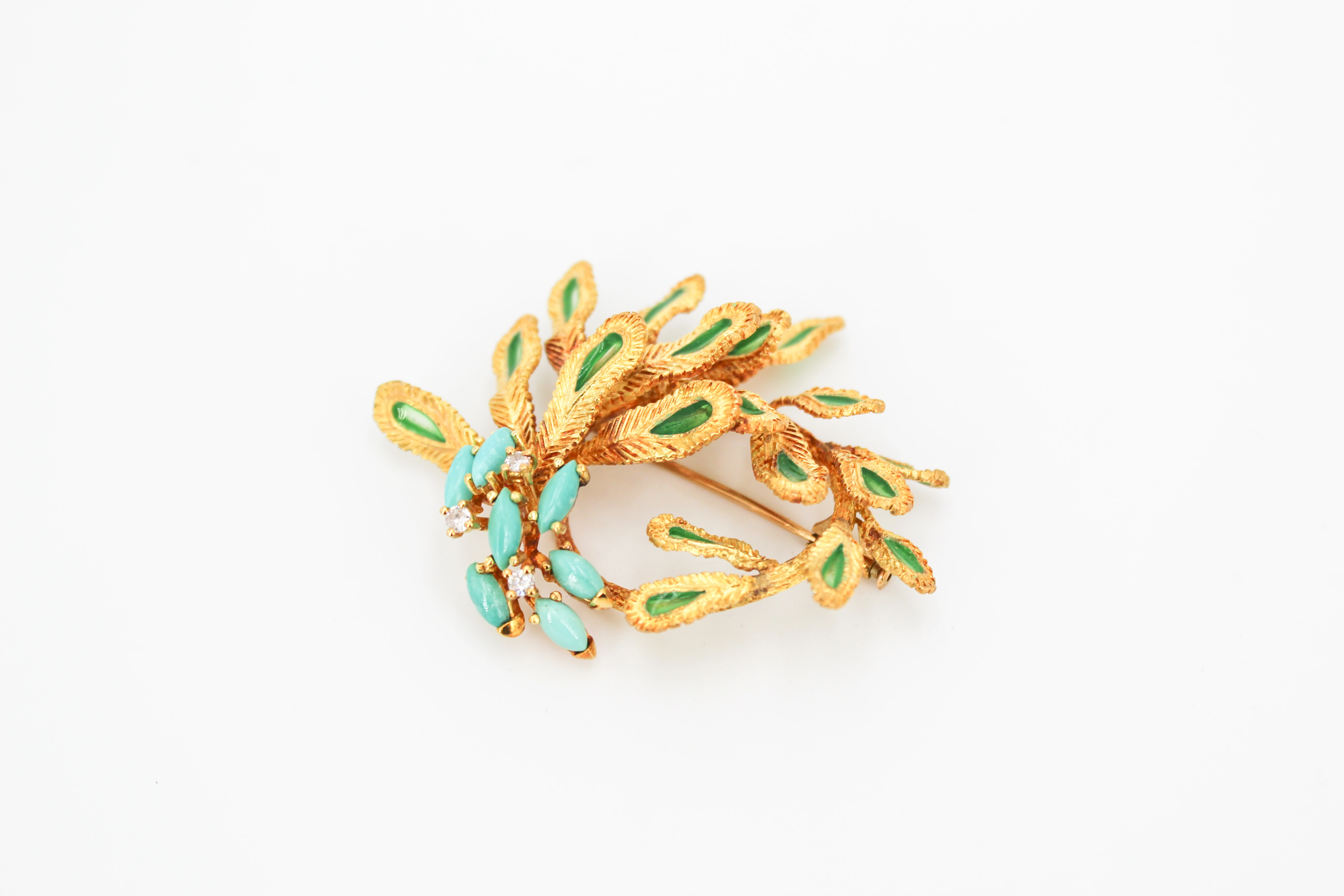 Broche de oro de 18k con diseño floral y piedras de turquesa